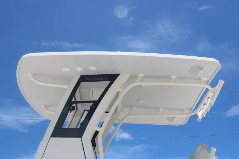 Slide: The Image of 2025 World Cat 235TE boat T-top against blue sky background. - 5