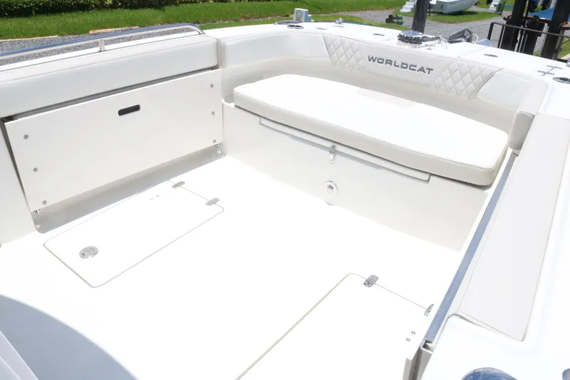 Slide: The Image of 2025 World Cat 235TE boat interior with white seating and storage compartments. - 8