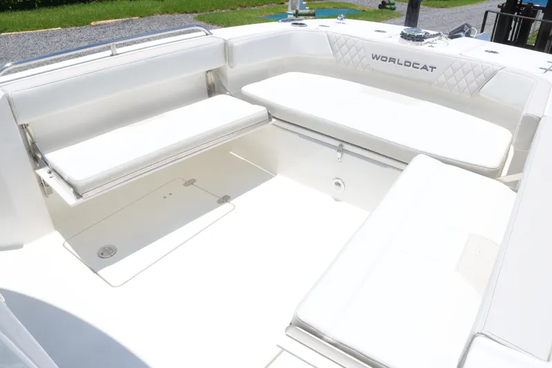 Slide: The Image of 2025 World Cat 235TE boat interior with white seating and storage compartments. - 9