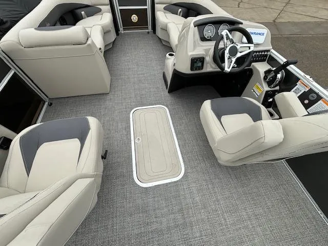 Slide: The Image of 2024 Barletta ARIA 22UC pontoon boat interior with gray flooring and beige seating. - 16