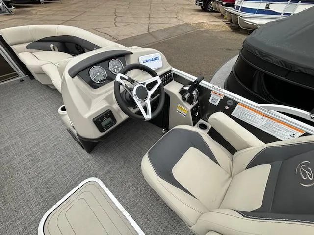 Slide: The Image of 2024 Barletta ARIA 22UC boat interior with steering wheel and seating. - 18