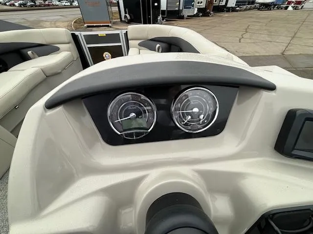 Slide: The Image of 2024 Barletta ARIA 22UC boat dashboard with gauges and steering wheel. - 20