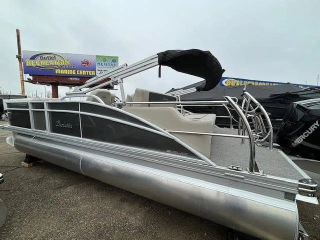 Slide: The Image of 2024 Barletta ARIA 22UC pontoon boat displayed at a marine center. - 3