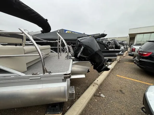 Slide: The Image of 2024 Barletta ARIA 22UC pontoon boat with Mercury outboard motor in a dealership lot. - 4