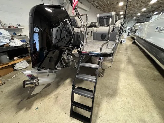 Slide: The Image of 2024 Barletta Lusso 23M pontoon boat with outboard motor in a showroom. - 14