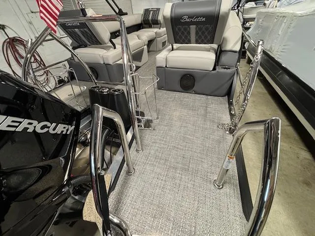 Slide: The Image of 2024 Barletta Lusso 23M pontoon boat interior with luxurious seating and Mercury engine. - 16