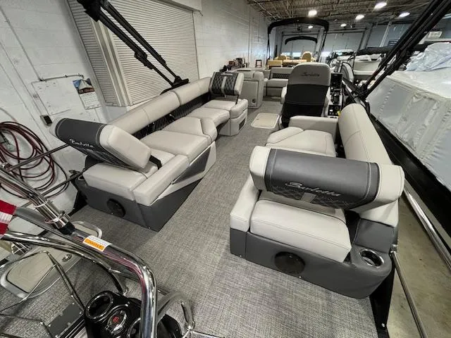 Slide: The Image of 2024 Barletta Lusso 23M pontoon boat interior with luxurious seating and modern design. - 17