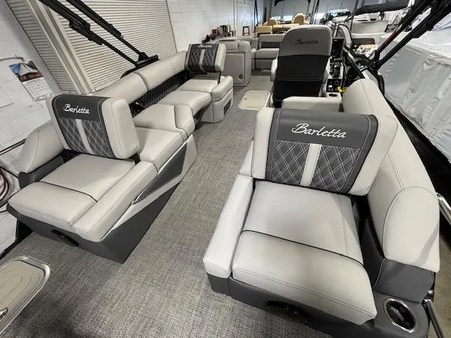 Slide: The Image of 2024 Barletta Lusso 23M luxury pontoon boat interior with plush seating and modern design. - 18