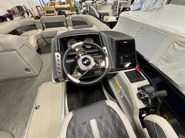 Slide: The Image of 2024 Barletta Lusso 23M boat interior with steering wheel and seating. - 21