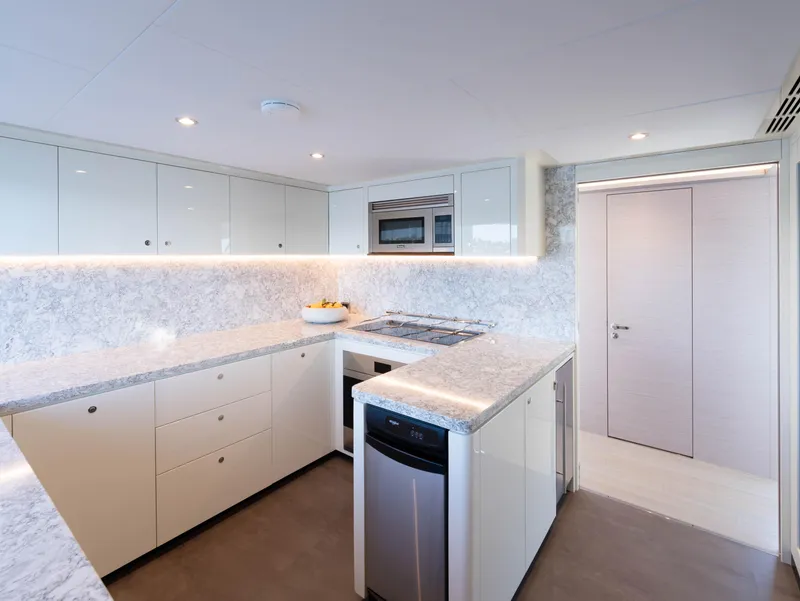 Slide: The Image of Modern kitchen in 2024 Ocean Alexander 32L yacht with sleek cabinetry and marble countertops. - 15