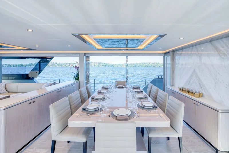 Slide: The Image of Luxurious dining area on the 2024 Ocean Alexander 32L yacht with ocean view. - 17