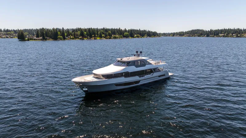 Slide: The Image of 2024 Ocean Alexander 32L luxury yacht cruising on a serene lake. - 2
