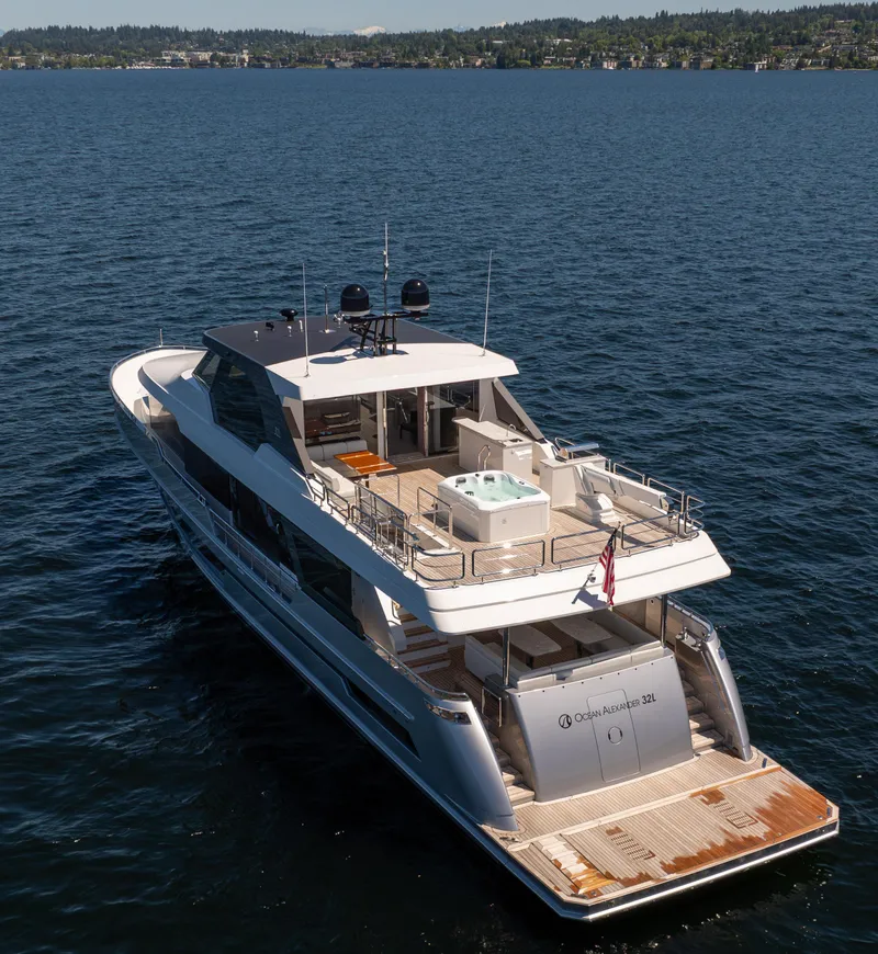 Slide: The Image of 2024 Ocean Alexander 32L luxury yacht cruising on a serene lake. - 3