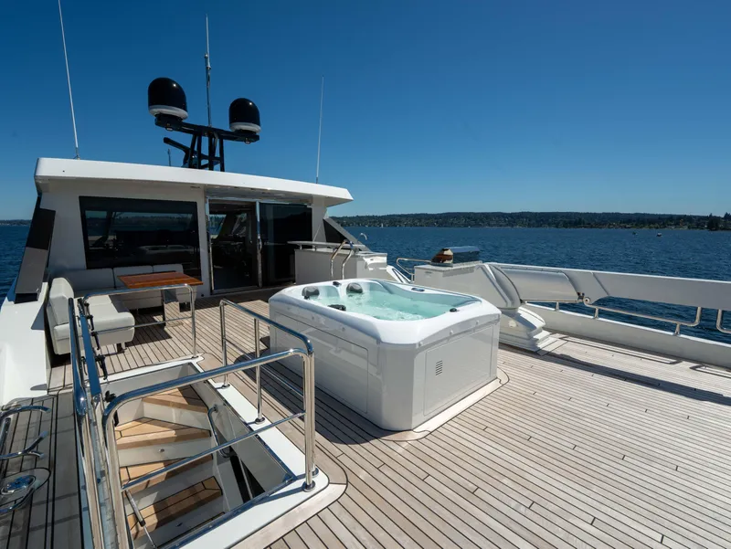 Slide: The Image of Luxury deck of 2024 Ocean Alexander 32L yacht with hot tub and seating area. - 31