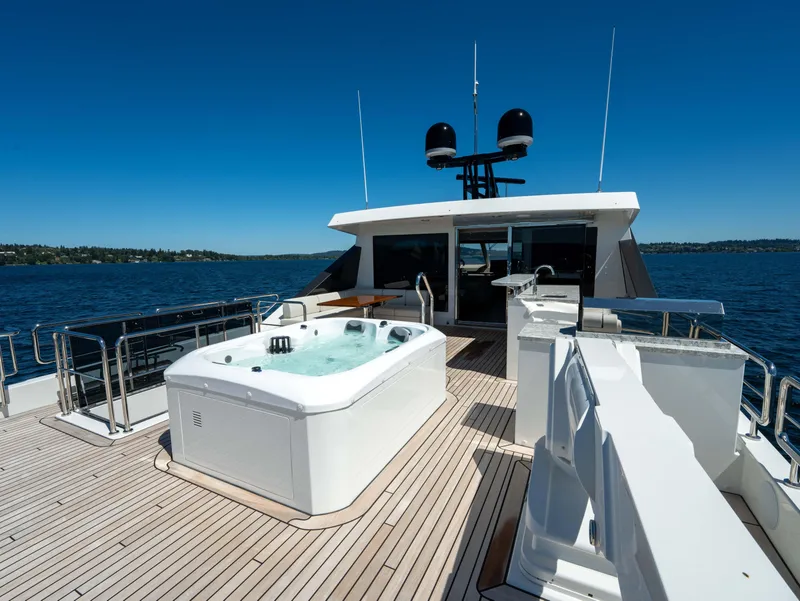 Slide: The Image of 2024 Ocean Alexander 32L yacht with jacuzzi on deck, cruising on a sunny day. - 33