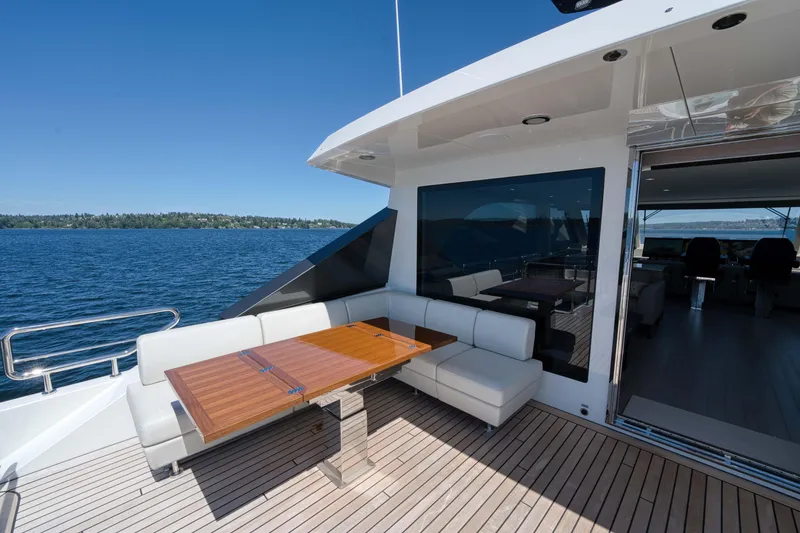 Slide: The Image of 2024 Ocean Alexander 32L yacht with outdoor seating and dining area on deck. - 34