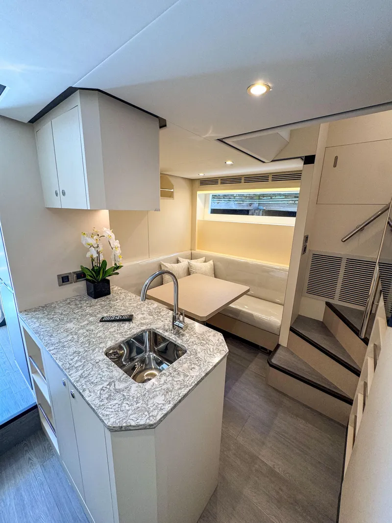 Slide: The Image of Luxurious interior of 2024 Ocean Alexander 32L yacht with modern kitchen and dining area. - 43