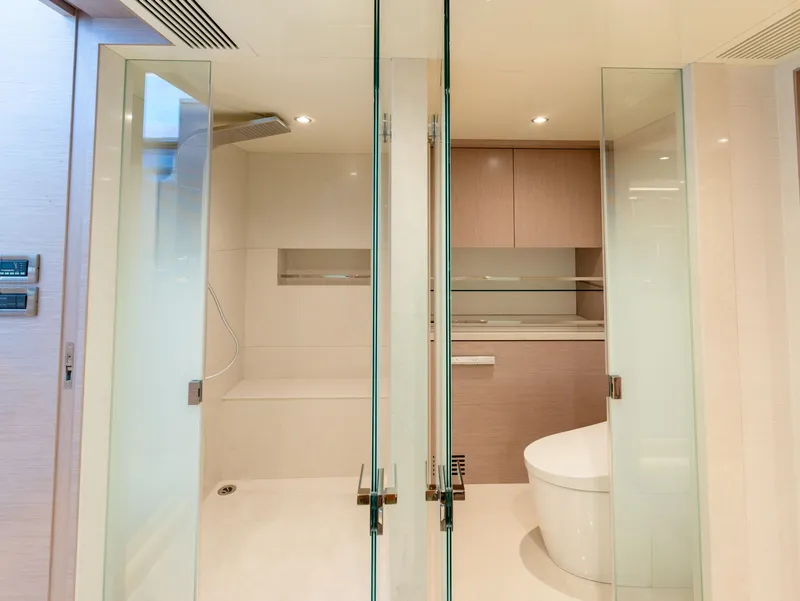 Slide: The Image of Luxurious bathroom in 2024 Ocean Alexander 32L yacht with glass doors and modern fixtures. - 7
