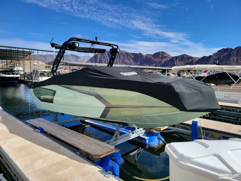 Slide: The Image of 2022 Heyday WT-Surf boat docked with cover, scenic mountain backdrop. - 11