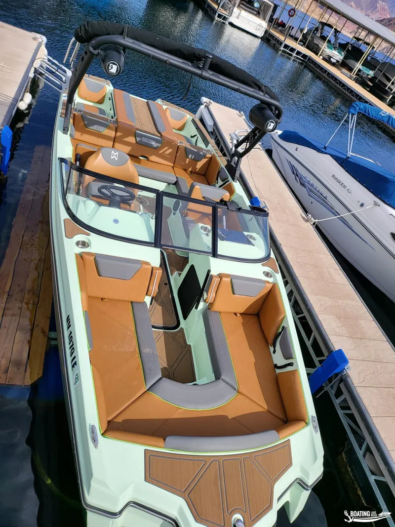 Slide: The Image of 2022 Heyday WT-Surf boat docked, featuring spacious seating and sleek design. - 2