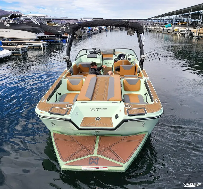 Slide: The Image of 2022 Heyday WT-Surf boat docked, featuring spacious seating and sleek design. - 3