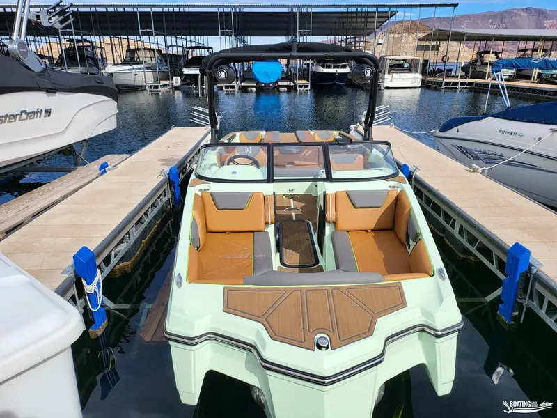 Slide: The Image of 2022 Heyday WT-Surf boat docked at marina, featuring sleek design and spacious seating. - 4