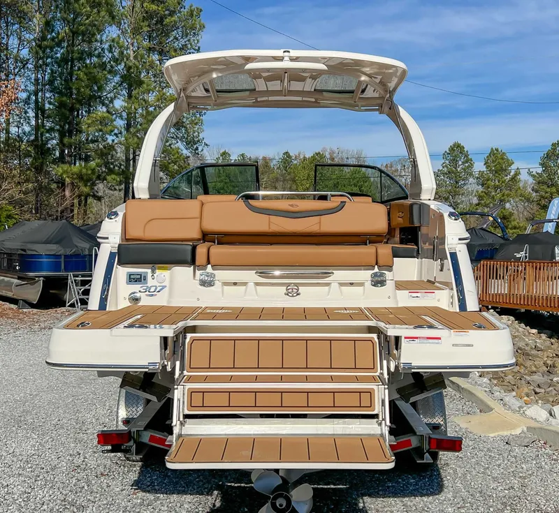 Slide: The Image of Rear view of 2024 Chaparral 307 SSX boat outdoors. - 12