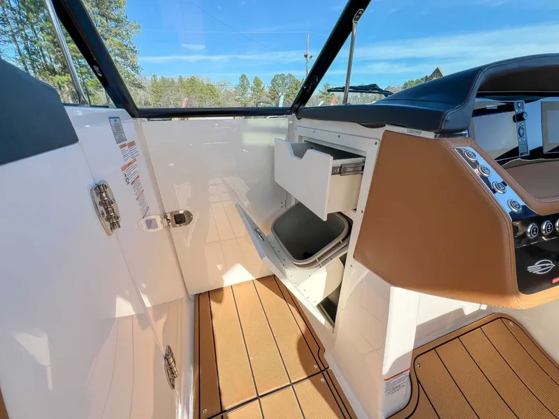 Slide: The Image of Interior of 2024 Chaparral 307 SSX featuring storage and controls. - 18