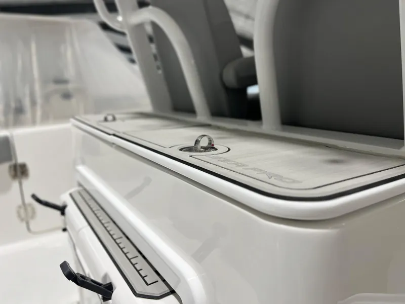 Slide: The Image of 2024 Sea Pro 322 DLX boat interior, close-up of storage compartments and seating. - 14