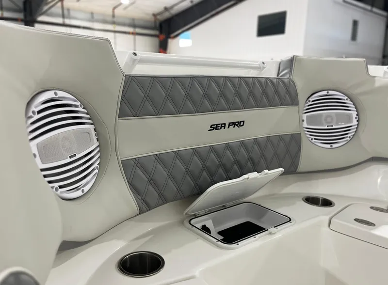Slide: The Image of 2024 Sea Pro 322 DLX boat interior with speakers and storage compartment. - 17