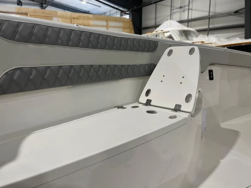 Slide: The Image of 2024 Sea Pro 322 DLX boat interior with cushioned seating and storage. - 18