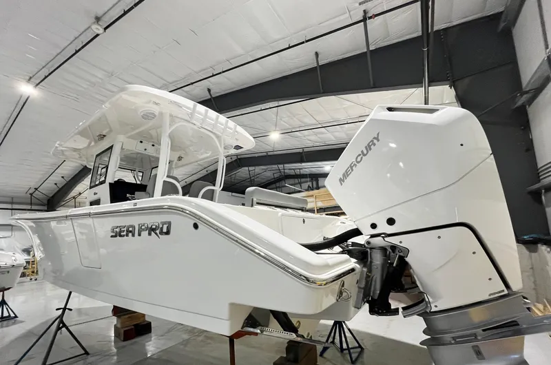 Slide: The Image of 2024 Sea Pro 322 DLX boat with Mercury engine in a showroom. - 4