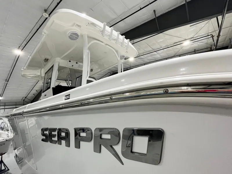 Slide: The Image of 2024 Sea Pro 322 DLX boat in a showroom, side view. - 15