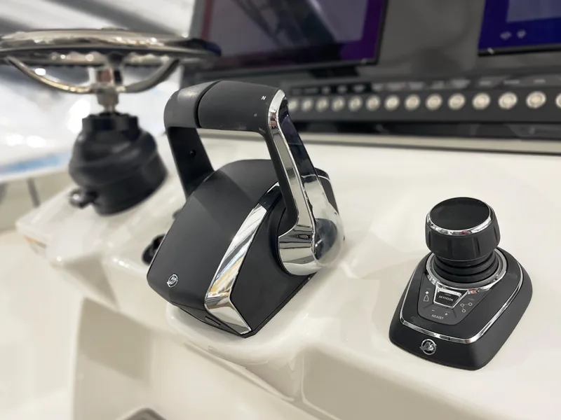 Slide: The Image of 2024 Sea Pro 322 DLX boat control panel with throttle and joystick. - 16