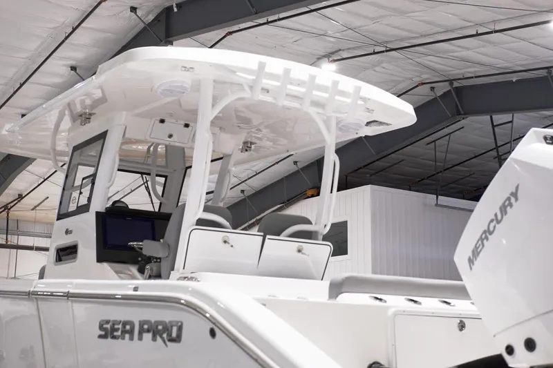 Slide: The Image of 2024 Sea Pro 322 DLX boat in a showroom with Mercury engine. - 20