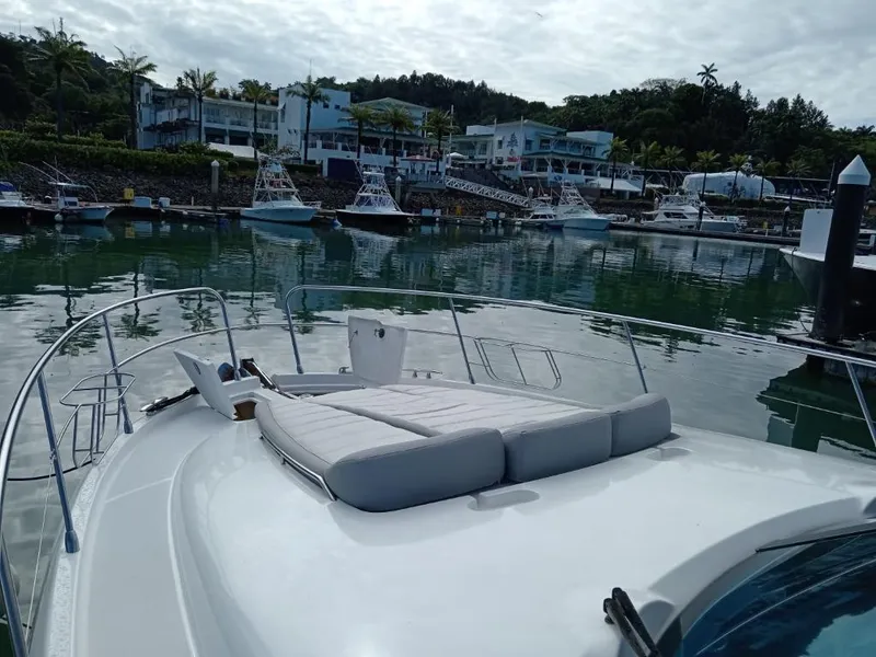 Slide: The Image of Prestige 46 yacht (2006) docked at a marina with scenic waterfront view. - 15