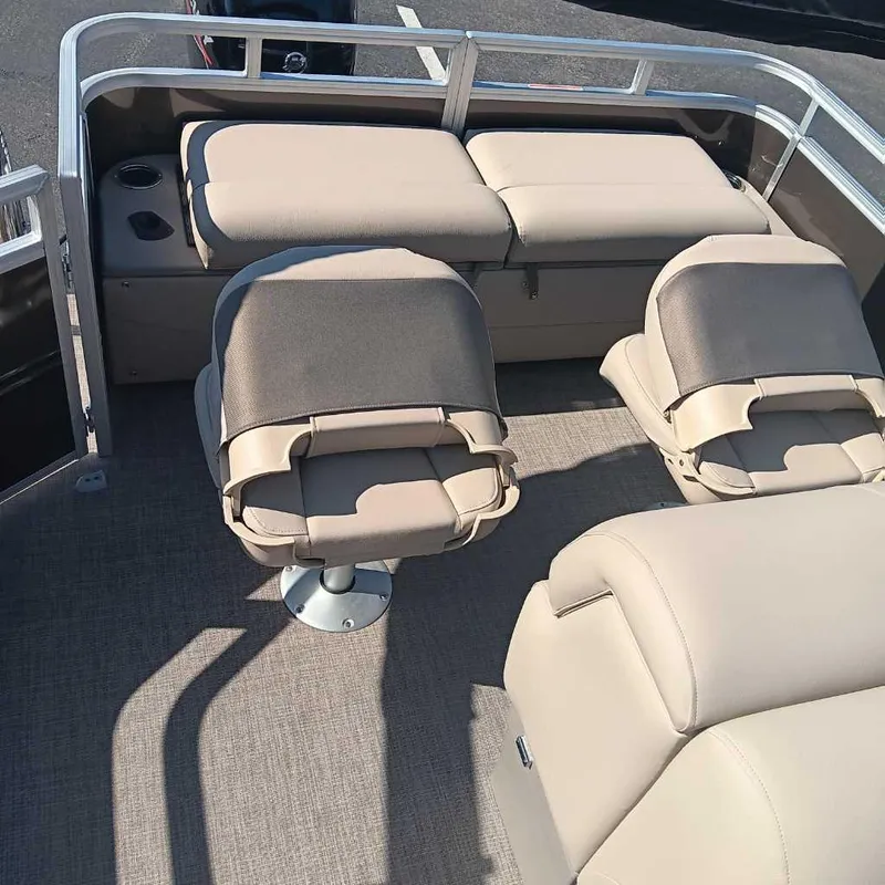 Slide: The Image of 2024 Sun Tracker SportFish 22 DLX interior with beige seating and fishing chairs. - 3