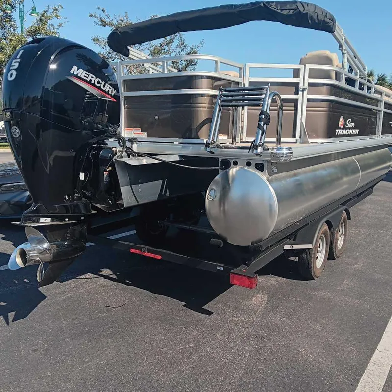 Slide: The Image of 2024 Sun Tracker SportFish 22 DLX pontoon boat with Mercury outboard engine. - 5