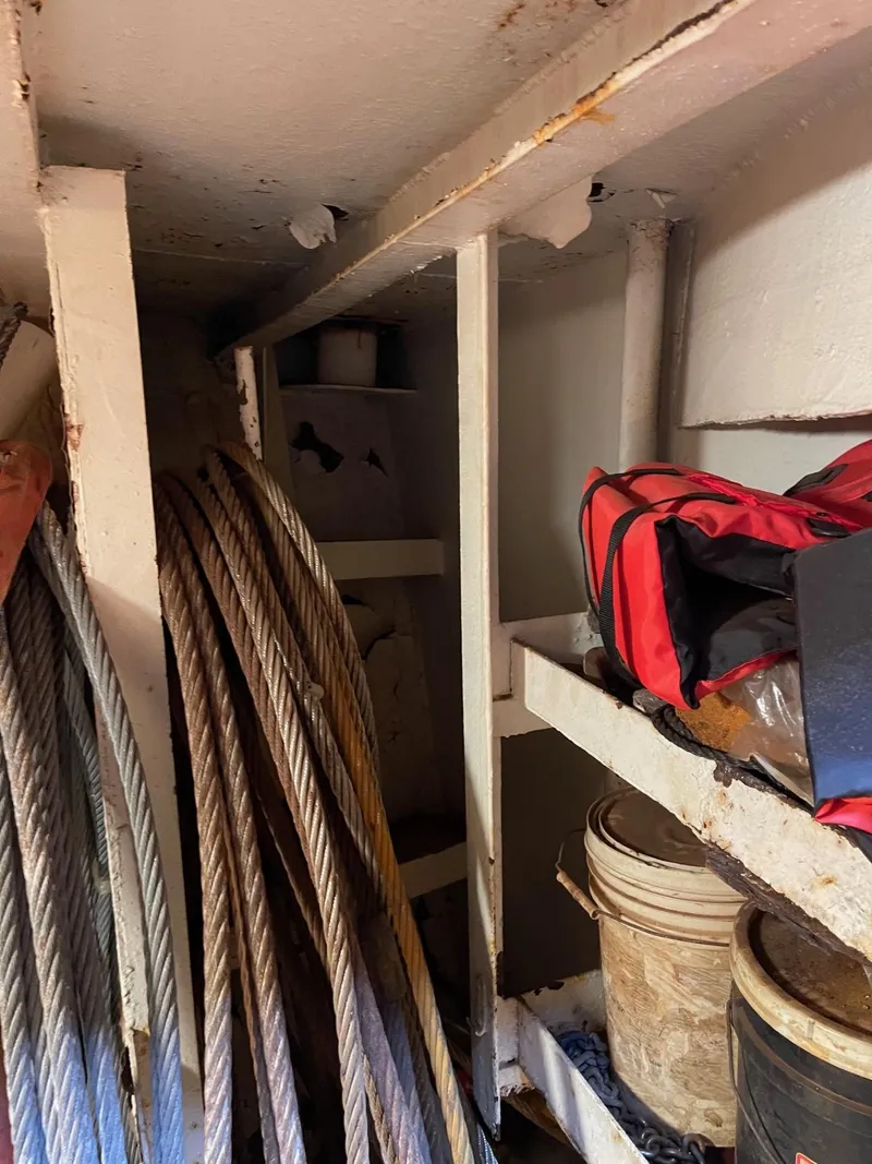 Slide: The Image of Storage area inside a 1961 Commercial Model Bow Tug with cables and equipment. - 11