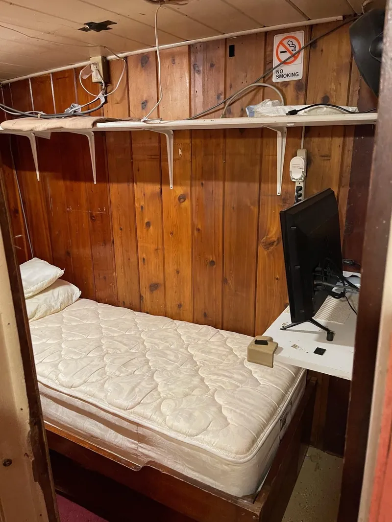 Slide: The Image of Small cabin room in a 1961 Commercial Model Bow Tug with a bed and desk. - 19