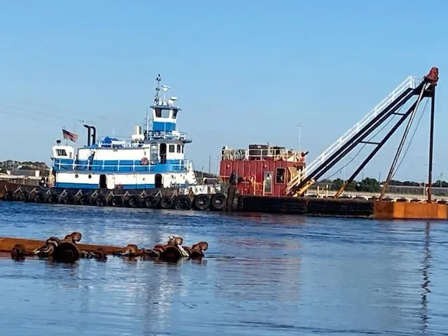 Slide: The Image of Tugboat Model Bow Tug (1961) towing a barge on a calm river. - 2