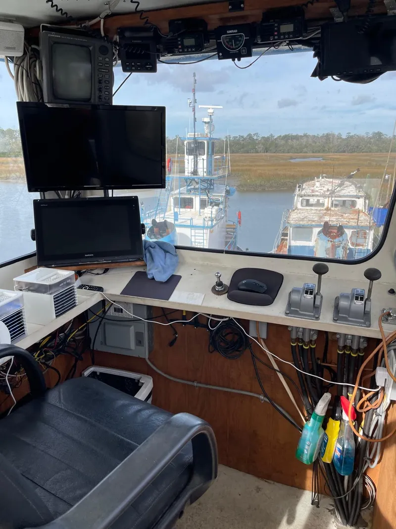 Slide: The Image of 1961 Commercial Model Bow Tug interior with control panel and river view. - 23