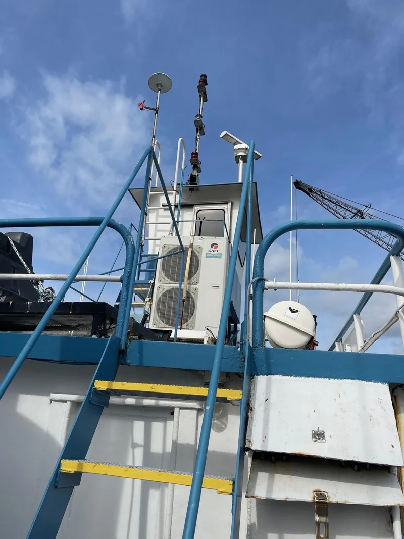 Slide: The Image of 1961 Commercial Model Bow Tug with blue railings and equipment on deck. - 4