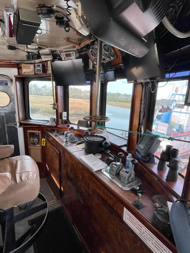 Slide: The Image of 1961 Commercial Model Bow Tug interior with control panels and navigation equipment. - 9