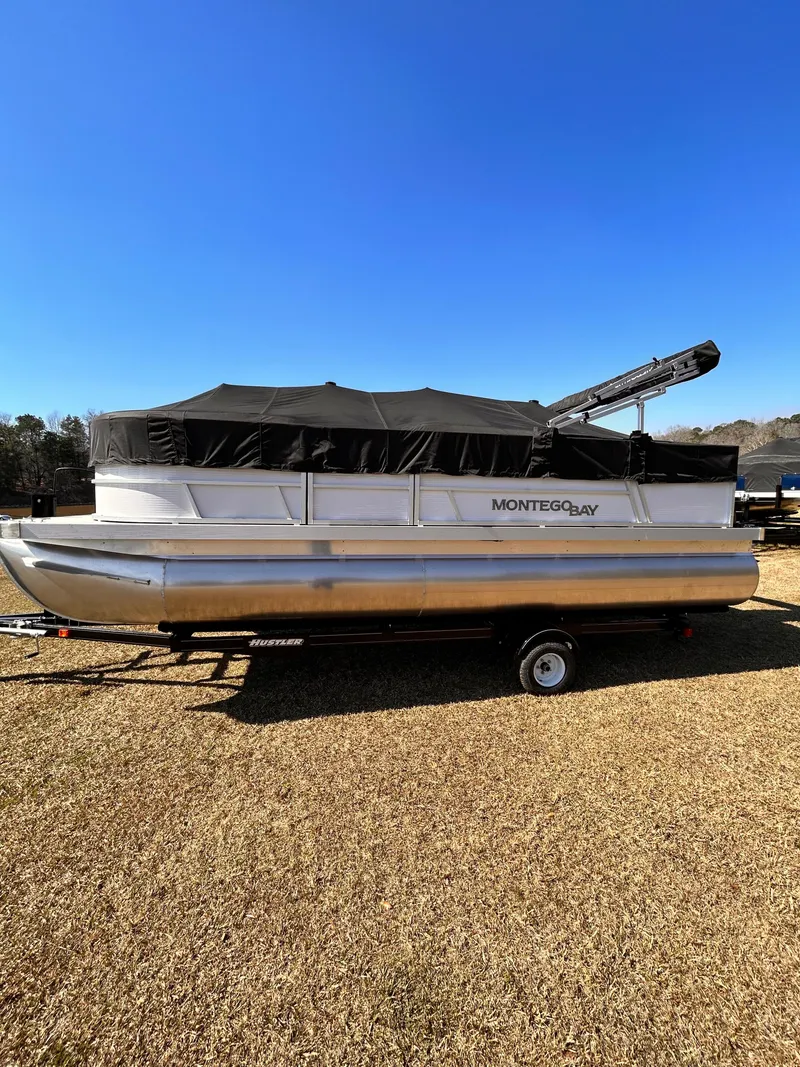Slide: The Image of 2023 Montego Bay 8520 pontoon boat with black canopy on a trailer. - 15