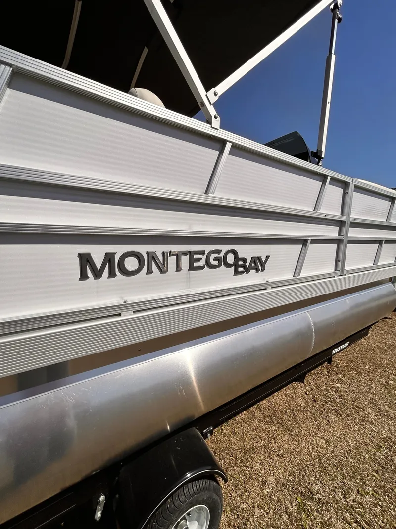 Slide: The Image of 2023 Montego Bay 8520 pontoon boat side view with logo. - 2