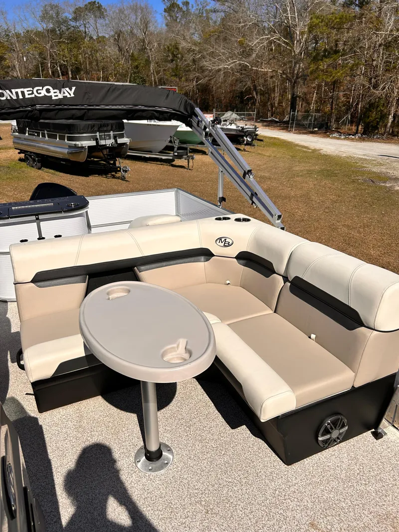 Slide: The Image of 2023 Montego Bay 8520 pontoon boat with beige seating and table. - 7