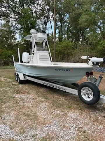 Slide: The Image of 2016 Avenger 26 boat on trailer, parked outdoors near trees. - 3