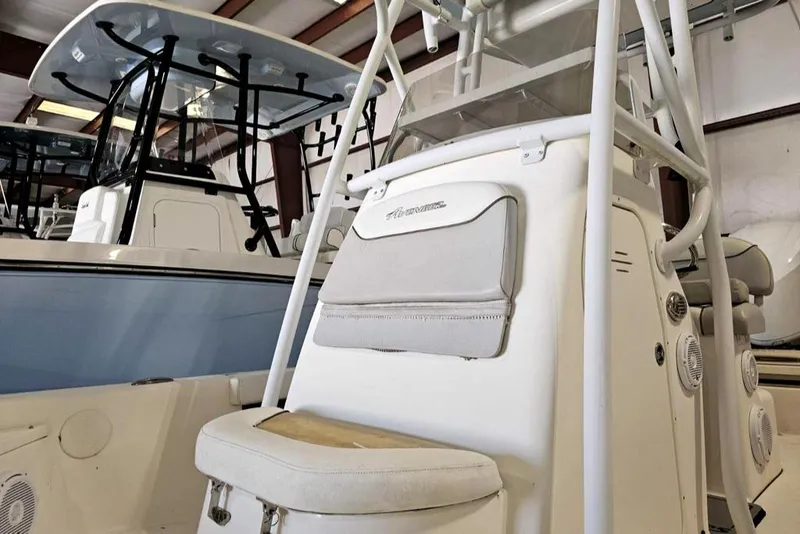 Slide: The Image of 2016 Avenger 26 boat interior with seating and console in a storage facility. - 4