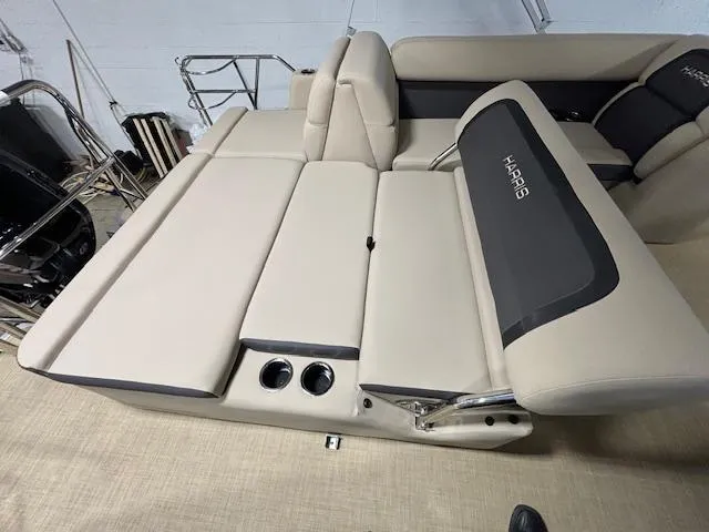 Slide: The Image of 2024 Harris Cruiser 210 boat interior with beige seating and cup holders. - 13